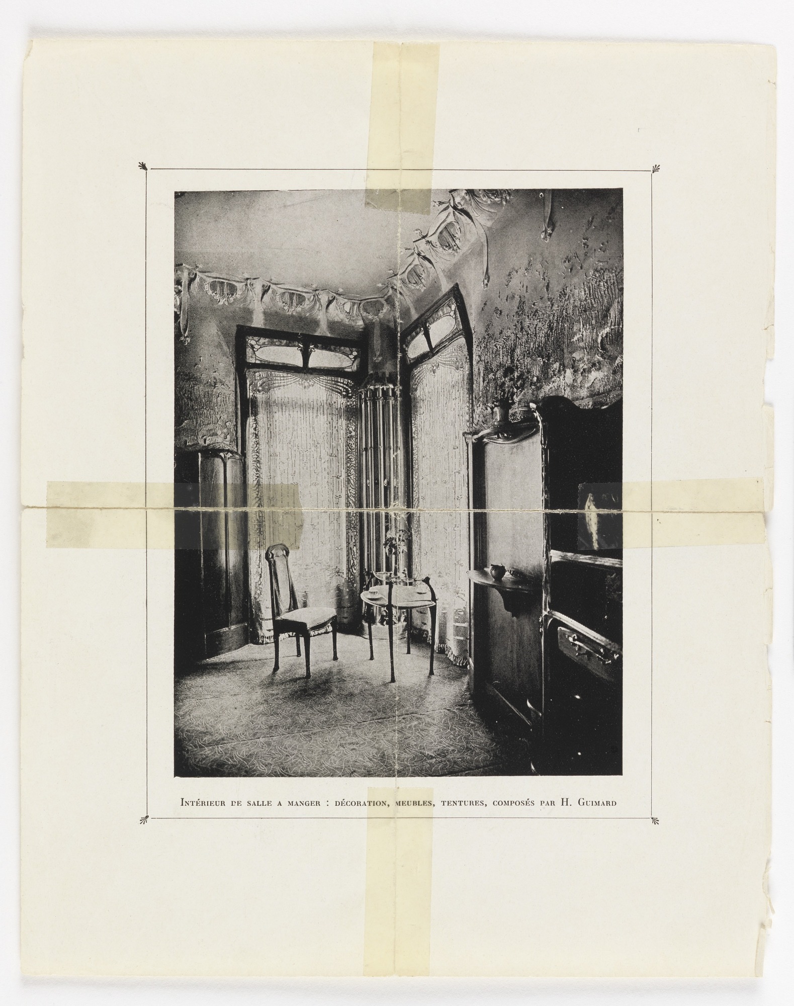Archival black-and-white Art Nouveau dining room with curved partition-like frames, a small round table, slender chairs, and patterned surfaces